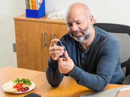 imaging showing Veteran using a glucose meter